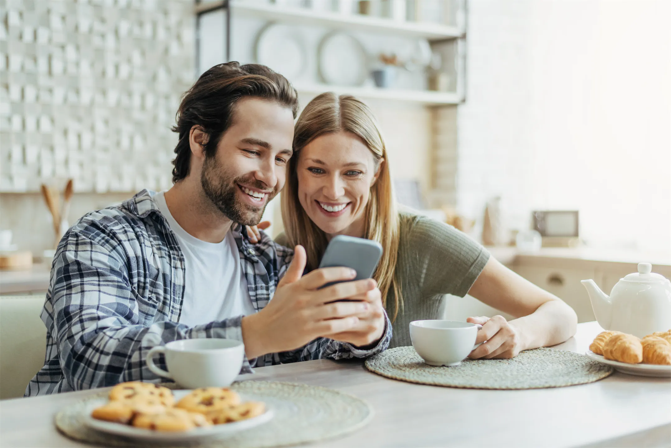 Kitchen and Bathroom Remodeling Reviews for Jericho Home Improvements Couple in Kansas City reading Jericho's 5-Star Online Reviews